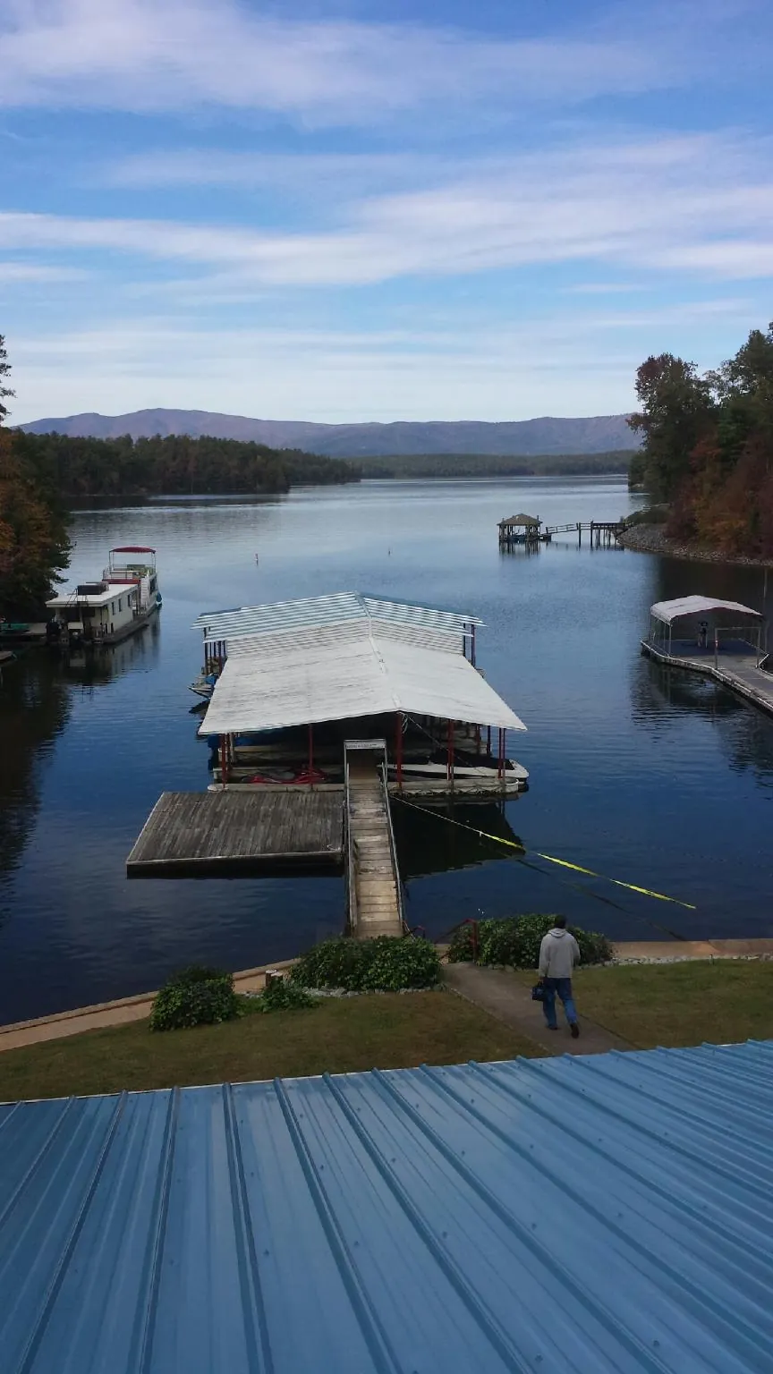 View across a lake from a newly installed blue metal roof in Basking Ridge
